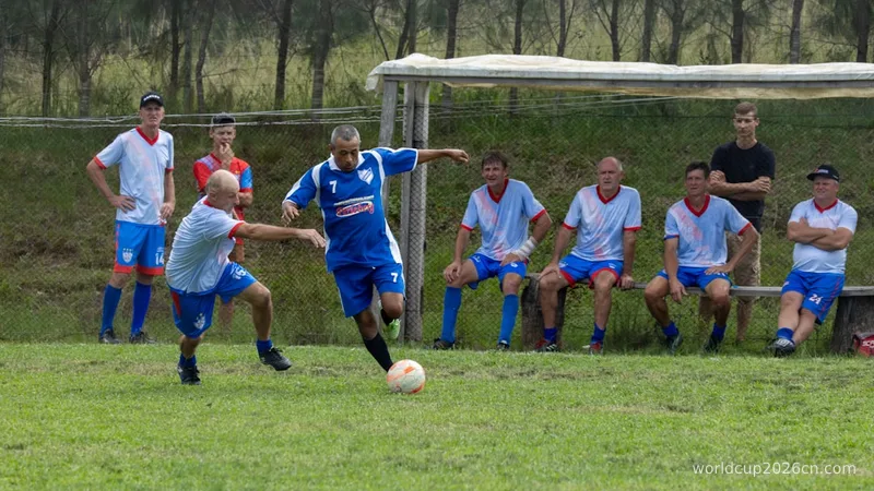 Men playing soccer on a grassy field