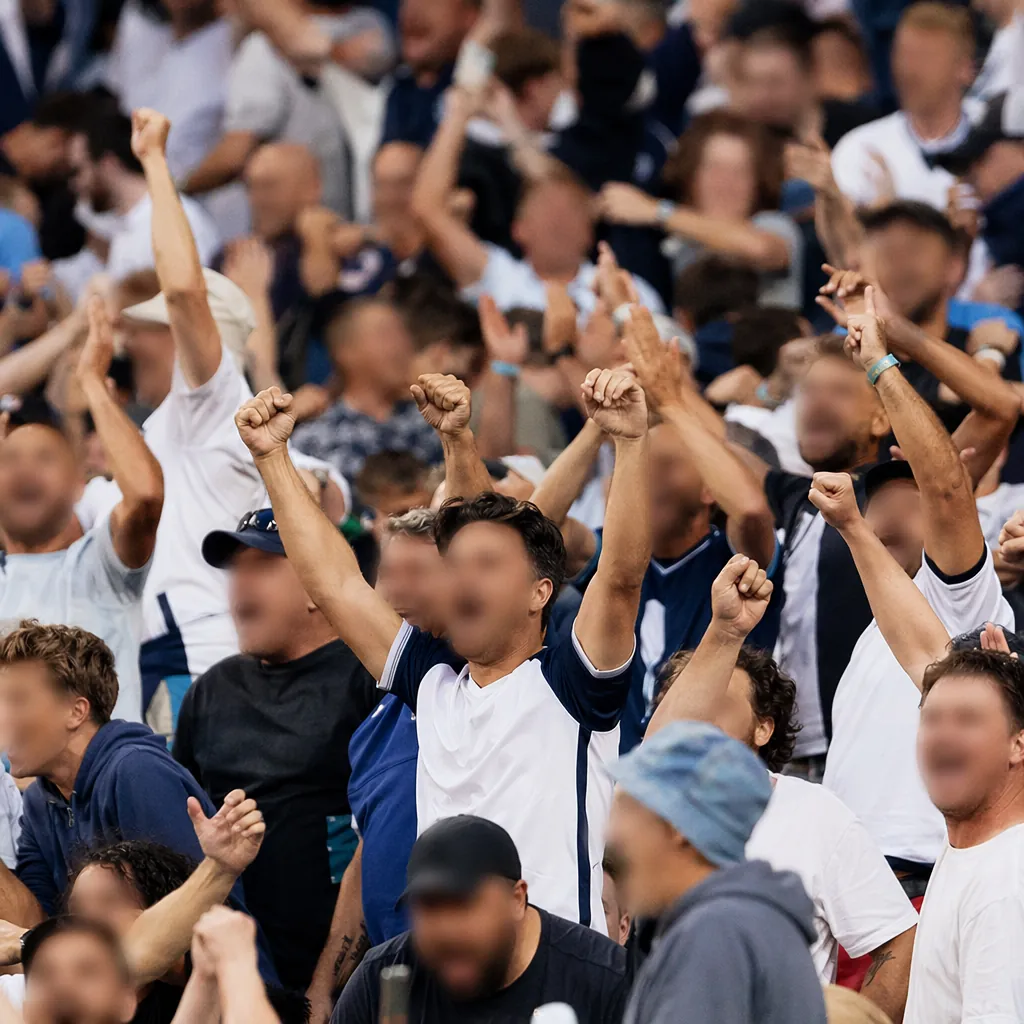 Crowd of generic football fans cheering in stadium stands, wearing neutral color