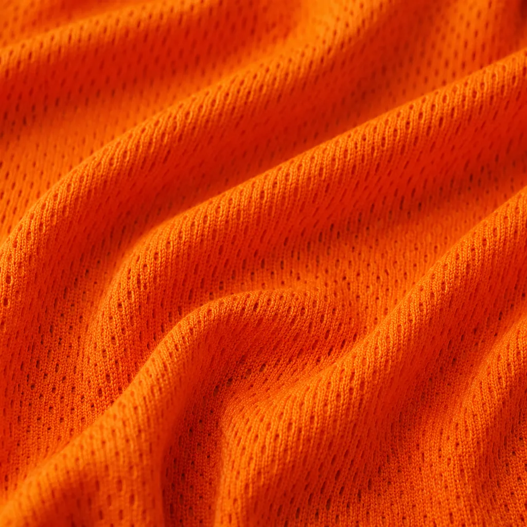 Detail of breathable sports jersey fabric texture, bright orange color, soft lig